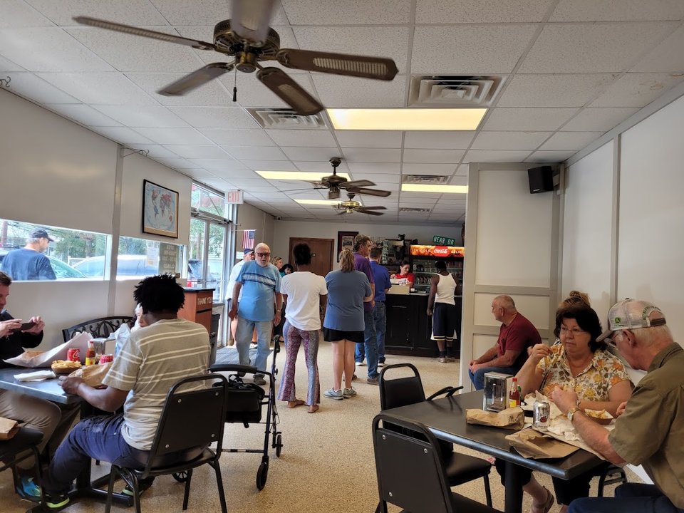 Po' boys served in a busy storefront.